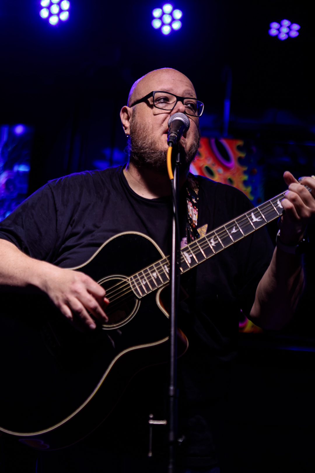 Anthony Gaff singing with an acoustic guitar